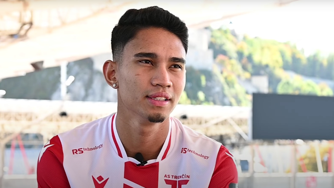 Marselino Ferdinan saat wawancara, mengenakan jersey klub AS Trenčín merah putih dengan logo RS Technology.