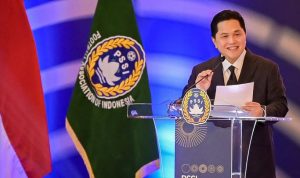 Ketua-PSSI-Erick-Thohir-Pidato-Piala-Asia-Pelatih-Timnas.webp Ketua PSSI Erick Thohir berpidato di podium, diapit bendera Indonesia dan logo PSSI, terkait pencarian pelatih Timnas.