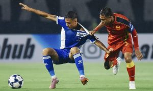 Duel-Panas-AFC-Champions-League-Two-Persib-Selangor.jpg Dua pemain sepak bola, satu berseragam biru-putih dan satu berseragam merah-kuning, berduel di lapangan, menunjukkan intensitas pertandingan.