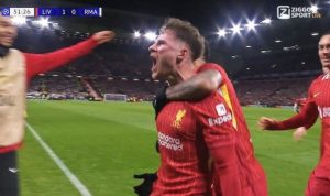 Liverpool-Rayakan-Gol-Liga-Champions-vs-Madrid.jpg Pemain Liverpool berseragam merah merayakan gol dengan teriakan kegembiraan, memeluk rekan setim di lapangan, menunjukkan skor "LIV 1-0 RMA" di papan skor.
