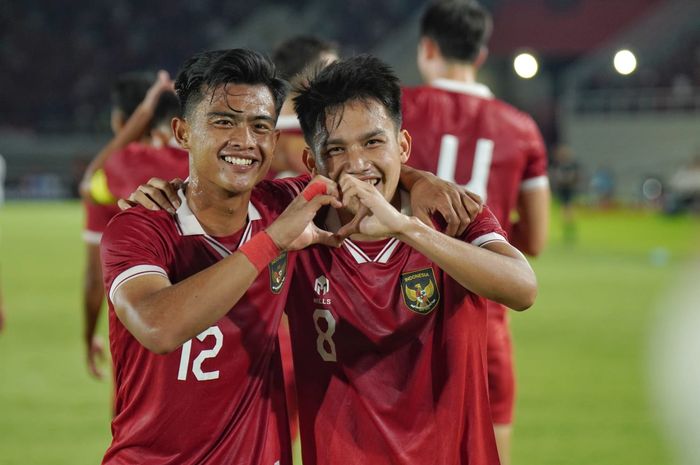 Pratama Arhan (nomor 12) dan Egy Maulana Vikri (nomor 8), dua bintang Timnas Indonesia, berpelukan dan membuat tanda hati dengan tangan di lapangan hijau.