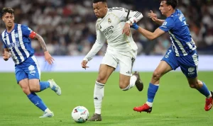 Pemain Real Madrid sedang menggiring bola di bawah tekanan pemain Deportivo Alaves dalam laga sengit Real Madrid vs Alaves.