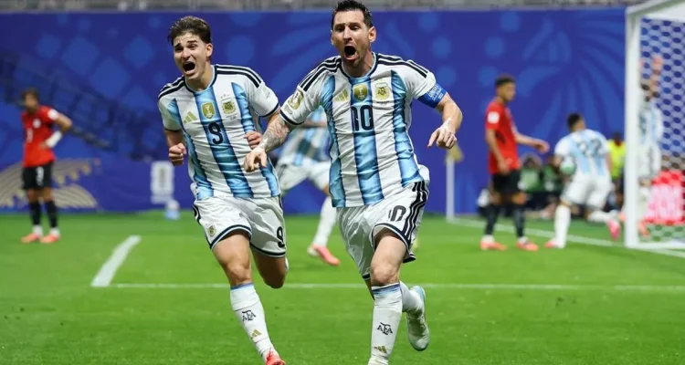 jadwal-siaran-langsung-argentina-vs-swiss-piala-dunia-2026.webp Lionel Messi dan Julian Alvarez dari timnas Argentina melakukan selebrasi gembira sambil berlari di lapangan hijau setelah mencetak gol.