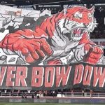 Koreografi 3D Macan Kemayoran dan spanduk Never Bow Down dari The Jakmania di tribun SUGBK