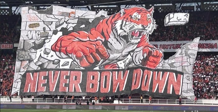 Koreografi 3D Macan Kemayoran dan spanduk Never Bow Down dari The Jakmania di tribun SUGBK