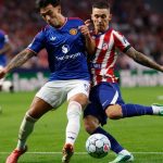 Lisandro Martinez pemain Manchester United sedang berduel memperebutkan bola dengan pemain Atletico Madrid.