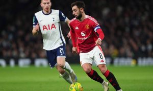 Bruno Fernandes menguasai bola untuk Manchester United saat dibayang-bayangi pemain Tottenham Hotspur